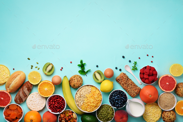 Healthy breakfast ingredients, food frame. Oat and corn flakes, eggs, nuts, fruits, berries, toast - Stock Photo - Images