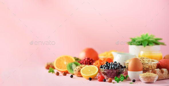 Healthy breakfast ingredients, food frame. Oat and corn flakes, eggs, nuts, fruits, berries, toast - Stock Photo - Images