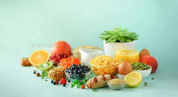 Vegetarian breakfast. Soft boiled egg, oat flakes, nuts, fruits, berries, milk, yogurt, orange - Stock Photo - Images