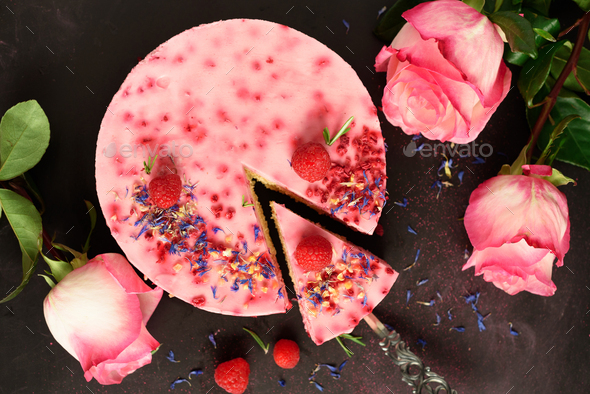 Pink roses and delicious raspberry cake with fresh berries, rosemary, dry flowers on dark vintage - Stock Photo - Images