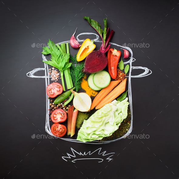 Food ingredients for blending creamy soup on painted stewpan over chalkboard. Top view with copy - Stock Photo - Images