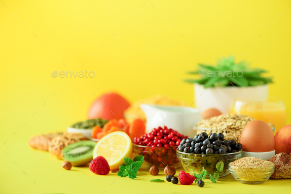 Healthy breakfast ingredients, food frame. Oat and corn flakes, eggs, nuts, fruits, berries, toast - Stock Photo - Images