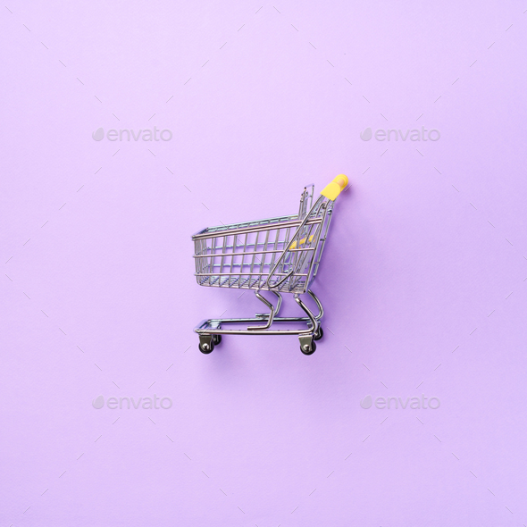 Shopping cart on purple background. Minimalism style. Square crop. Creative design. Top view with - Stock Photo - Images
