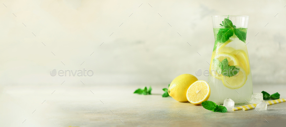 Detox water with mint, lemon on grey background. Banner with copy space. Citrus lemonade. Summer - Stock Photo - Images