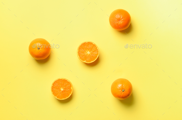 Fruit pattern of fresh orange slices on yellow background. Top view. Copy Space. Pop art design - Stock Photo - Images