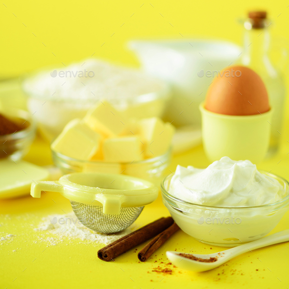 Holiday bakery background. Food frame - butter, sugar, flour, milk, eggs, oil, spoon, rolling pin - Stock Photo - Images
