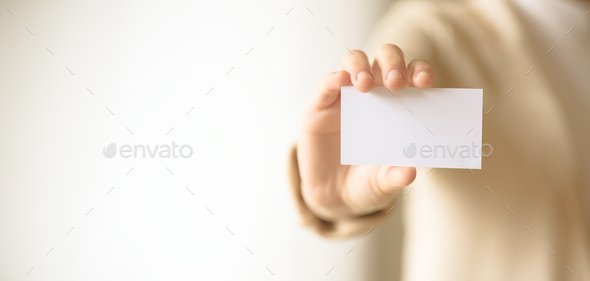 Businessman holding empty business card with copy space. Mock up. Business, study, network concept - Stock Photo - Images
