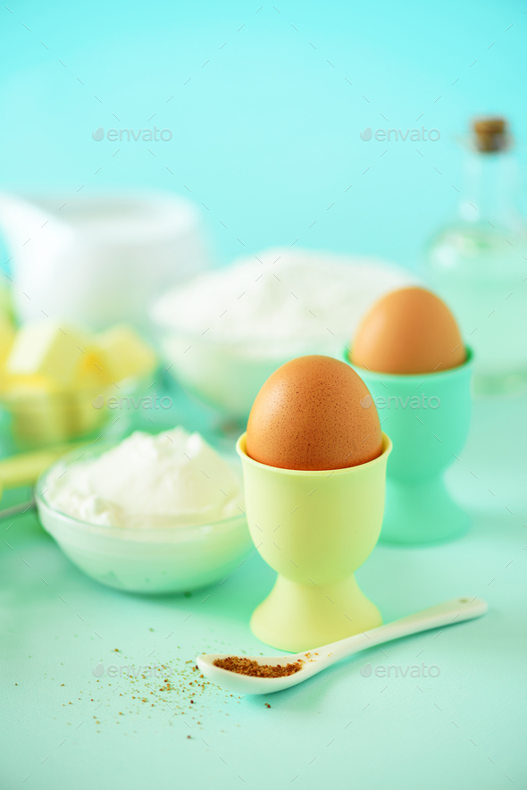 Healthy baking ingredients - butter, sugar, flour, eggs, oil, spoon, rolling pin, brush, whisk, milk - Stock Photo - Images