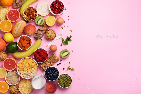 Organic food frame. Healthy breakfast ingredients. Oat and corn flakes, eggs, nuts, fruits, berries - Stock Photo - Images