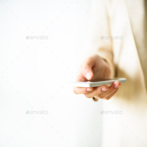 Woman hands hold cell phone on light cream background with copy space. Square crop. Business, study - Stock Photo - Images