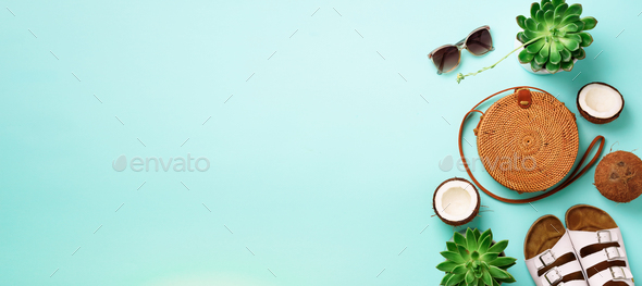 Stylish rattan bag, coconut, birkenstocks, succulent, sunglasses on blue background. Banner. Top - Stock Photo - Images