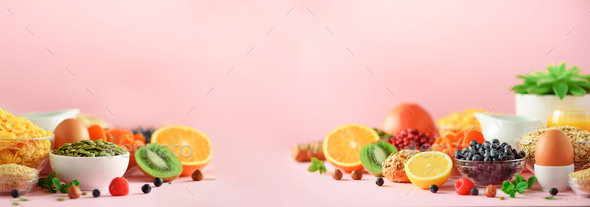 Organic food frame. Banner. Healthy breakfast ingredients. Oat and corn flakes, eggs, nuts, fruits - Stock Photo - Images
