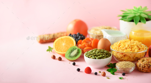 Vegetarian breakfast. Soft boiled egg, oat flakes, nuts, fruits, berries, milk, yogurt, orange - Stock Photo - Images