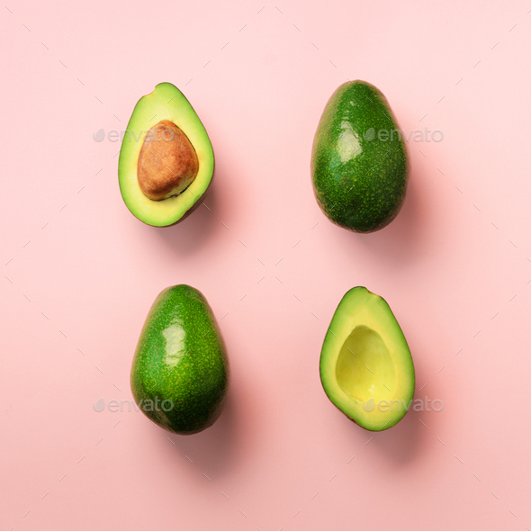 Organic avocado with seed, avocado halves and whole fruits on pink background. Top view. Square crop - Stock Photo - Images