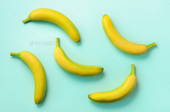 Colorful fruit pattern. Bananas over blue background. Top view. Pop art design, creative summer - Stock Photo - Images
