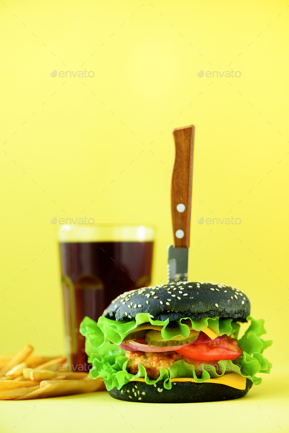 Fast food banner. Juicy meat burgers with cheese, lettuce on yellow background. Take away meal - Stock Photo - Images