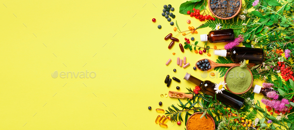 Holistic medicine approach. Healthy food eating, dietary supplements, healing herbs and flowers - Stock Photo - Images