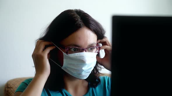 Woman Put on Mask, Reading New About Pandemia of Virus on Laptop, Looking Scared Shocked and