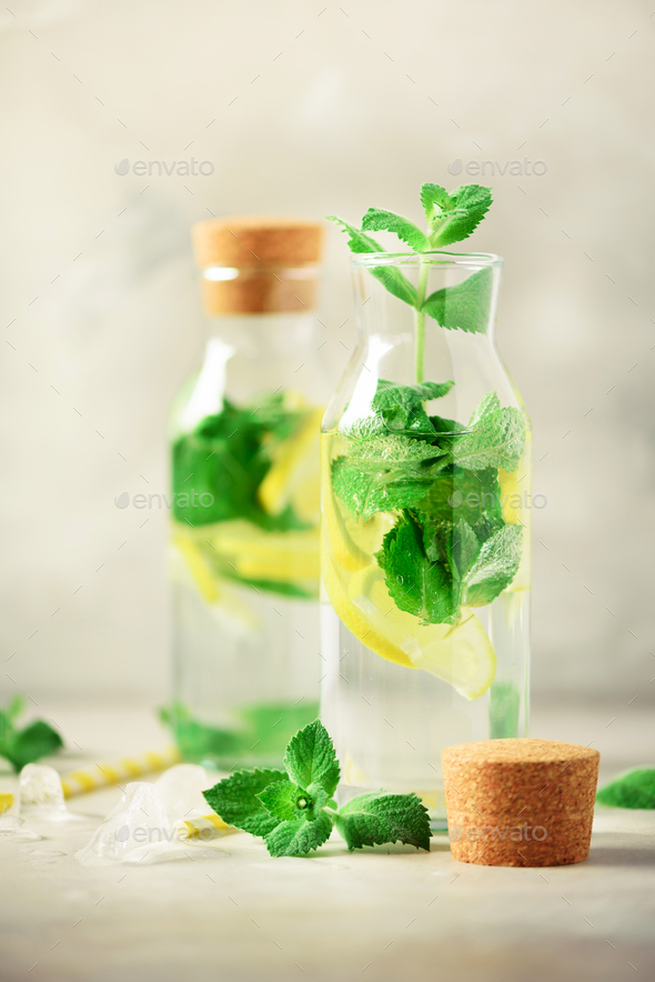 Citrus lemonade - mint, lemon and tropical monstera leaves on grey background. Detox drink. Summer - Stock Photo - Images