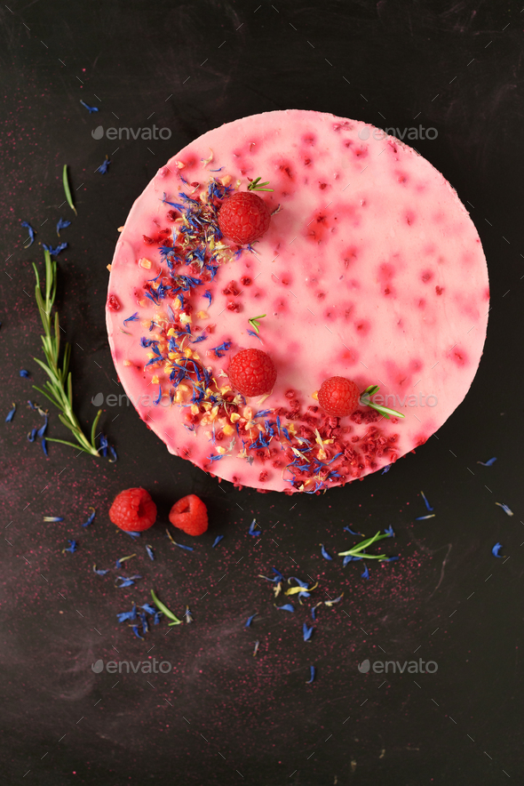 Delicious raspberry cake with fresh berries, rosemary and dry flowers on dark vintage background - Stock Photo - Images