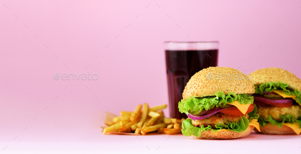 Fast food banner. Juicy meat burgers, french fries potatoes and cola drink on pink background. Take - Stock Photo - Images