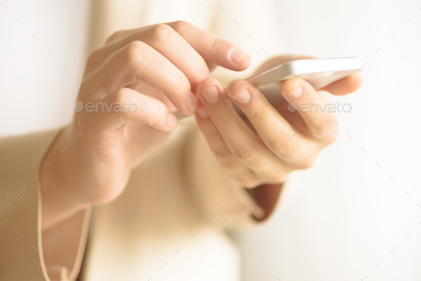 Businesswomen hand using smartphone on blur abstract background. Business, study, remote work - Stock Photo - Images