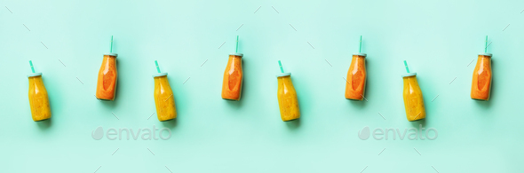 Fresh orange, banana, pineapple, mango smoothies and juicy fruits on blue background. Banner - Stock Photo - Images