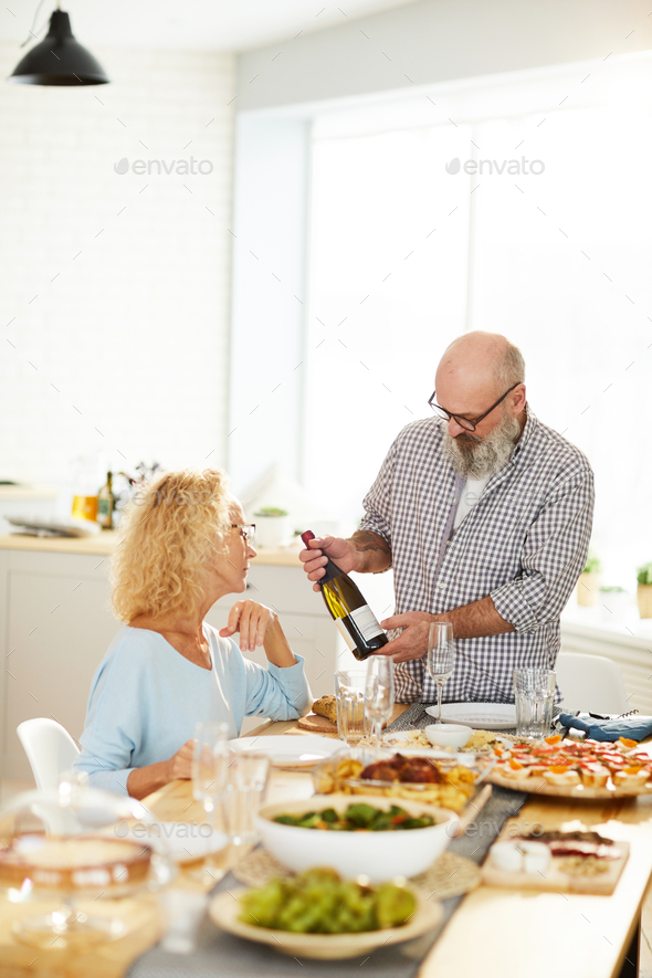 Man showing bottle of wine to girlfriend - Stock Photo - Images