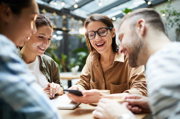 Positive friends gathering in cafe - Stock Photo - Images