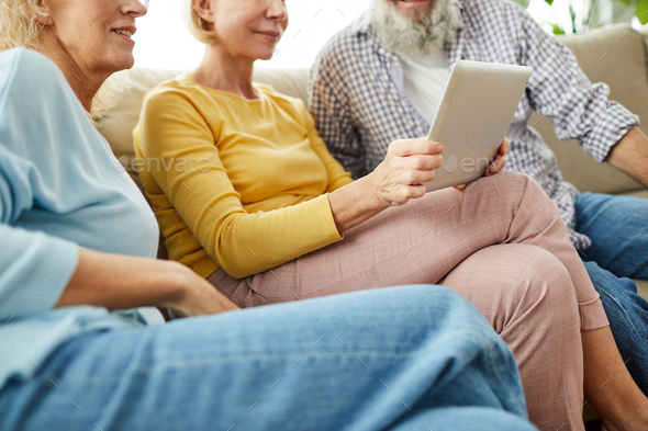 Aged friends watching video on tablet - Stock Photo - Images
