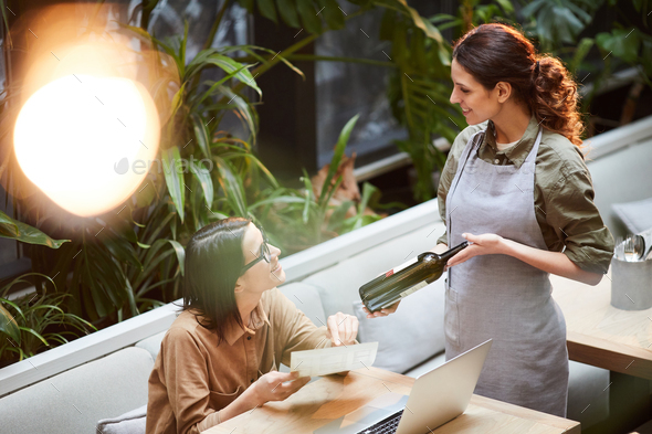Lady choosing wine in restaurant - Stock Photo - Images