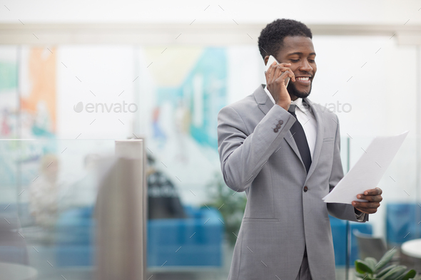 African Businessman Speaking by Phone - Stock Photo - Images