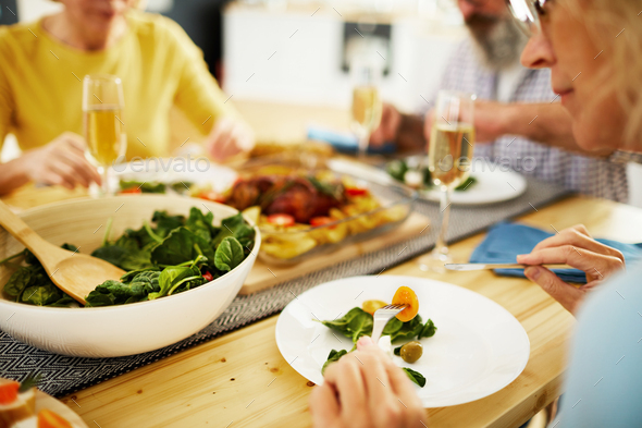 Eating fresh salad at dinner party - Stock Photo - Images