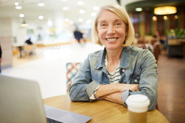 Cheerful freelance woman working in cafe - Stock Photo - Images