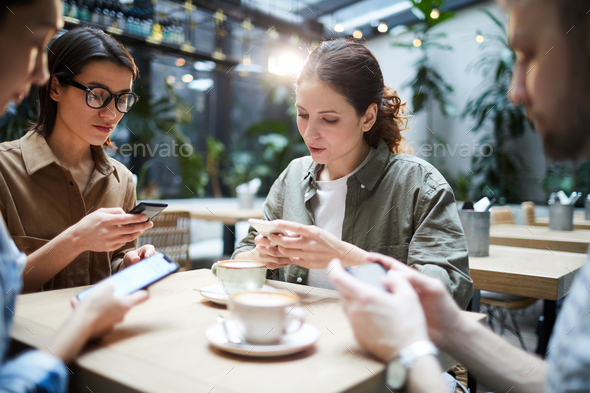 Gadget-addicted startuppers solving problem - Stock Photo - Images