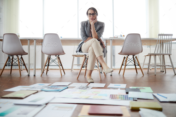 Businesswoman Planning Project in Empty Office - Stock Photo - Images