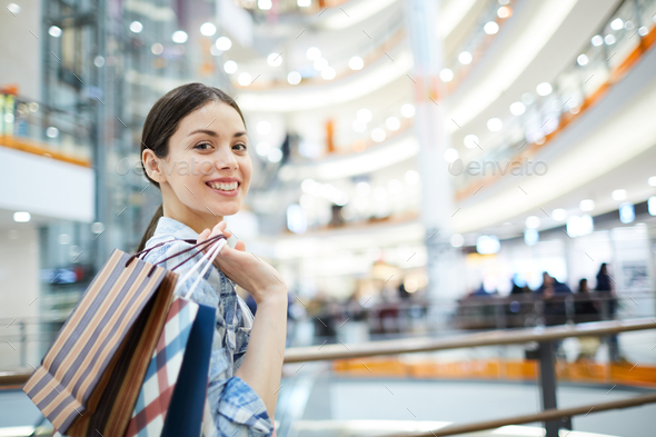 Positive girl with purchases - Stock Photo - Images