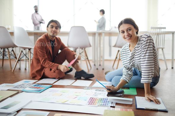 Two Designers Planning Project on Floor - Stock Photo - Images