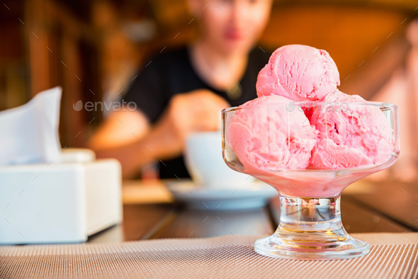 Close up three balls of strawberry ice cream in glass bowl - Stock Photo - Images