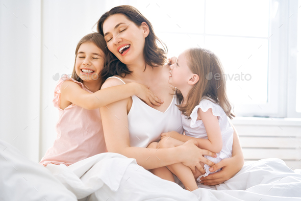 girls and their mother enjoy sunny morning - Stock Photo - Images