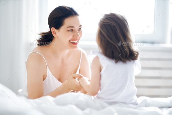 girl and her mother enjoy sunny morning - Stock Photo - Images