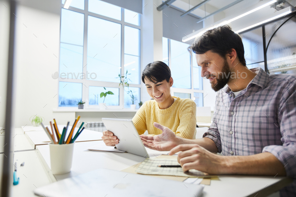 Positive colleagues discussing internet project - Stock Photo - Images