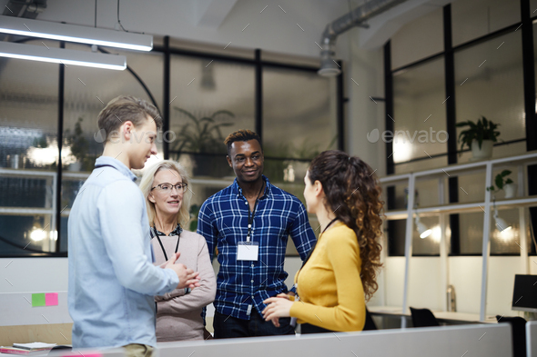 Multi-ethnic business team discussing presentation - Stock Photo - Images