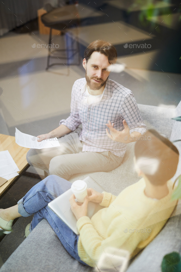 Young marketing specialists talking about project - Stock Photo - Images