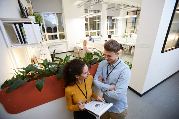 Lady presenting graphs to colleague - Stock Photo - Images