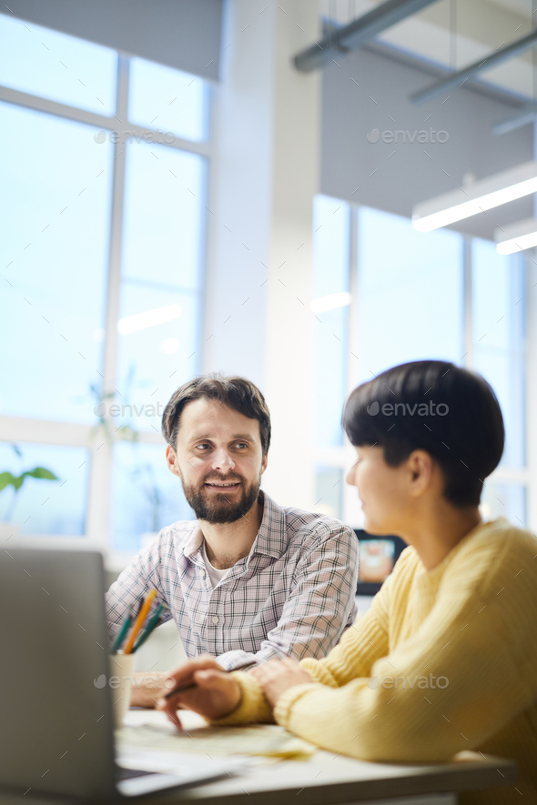Hipster colleagues discussing ideas in office - Stock Photo - Images