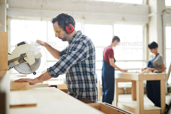 Using circular saw in workshop - Stock Photo - Images