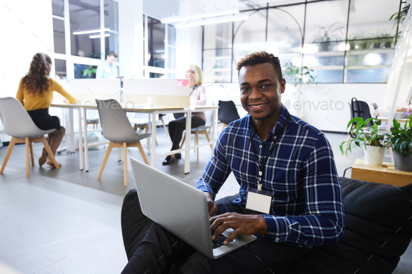 Cheerful black manager in comfortable office - Stock Photo - Images