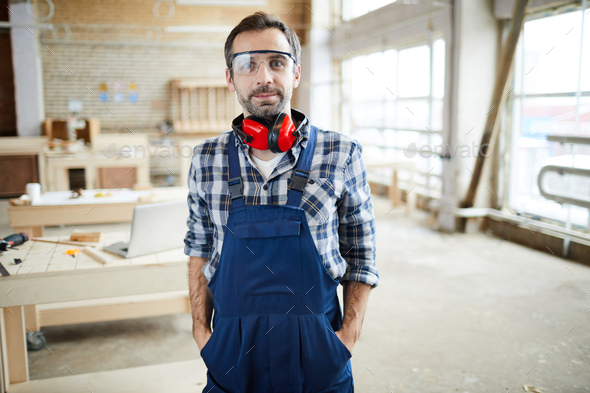 Content handsome carpenter in workshop - Stock Photo - Images