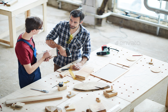 Showing how to make hole in wooden piece - Stock Photo - Images